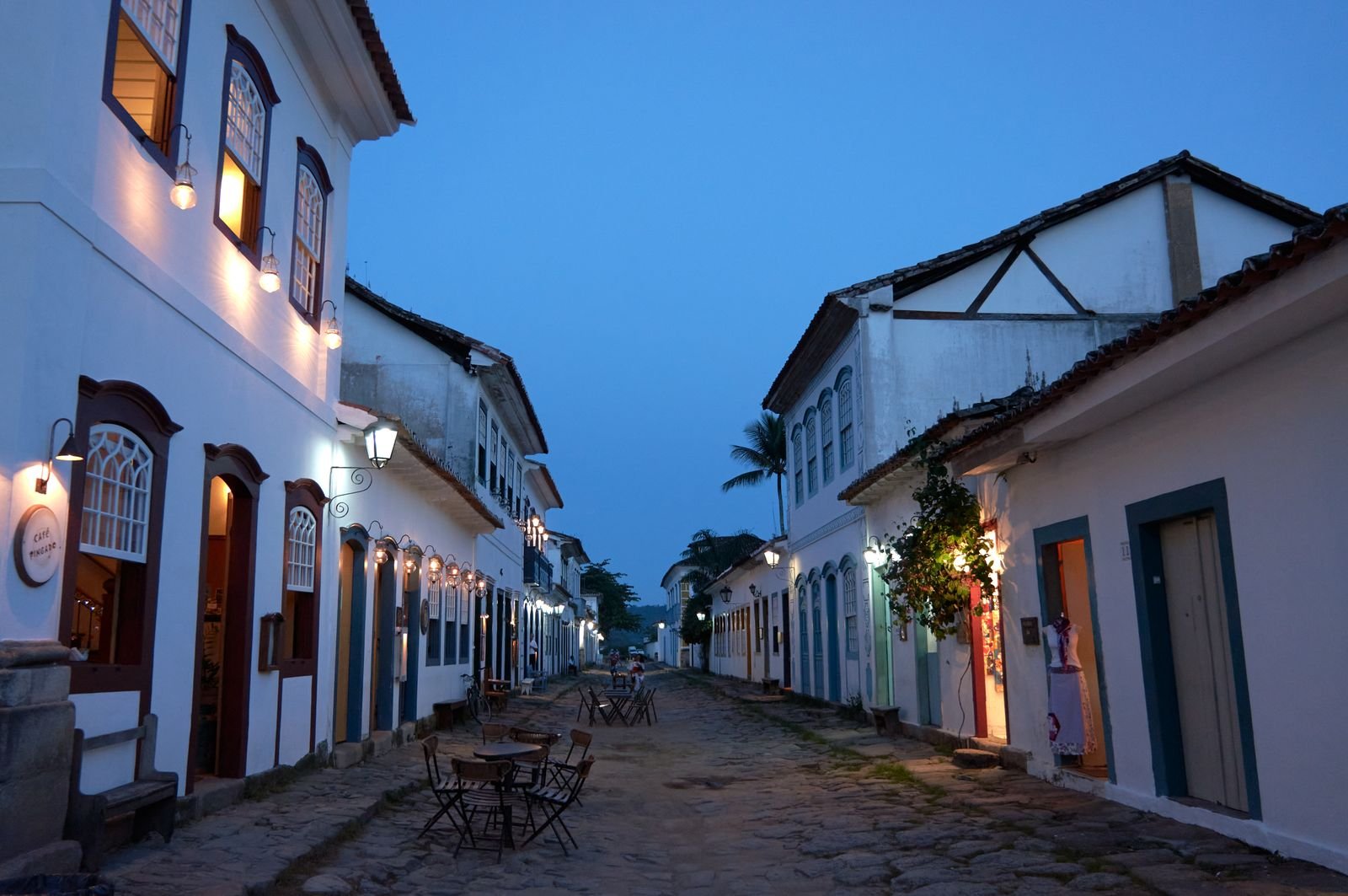 Rua de pedra no centro historico de Paraty com arquitetura colonial iluminada ao entardecer